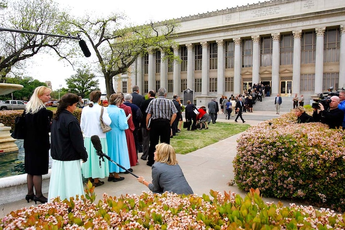 (Trent Nelson | The Salt Lake Tribune)
San Angelo, Texas - Hundred of attorneys, officials, and FLDS members lined up to get through security and into the Tom Green County Courthouse for the initial 14-day hearing to decide the fate of the 416 children removed in the raid on the FLDS Church's YFZ Ranch. As each child and parent were entitled to a state-appointed attorney, the hearing was quickly bogged down with objections from dozens of attorneys. After two long days of hearings, including twenty-one hours of testimony, Judge Barbara Walther ruled that CPS could keep the FLDS children in foster care until at least the next hearing, scheduled for two months after the raid began.