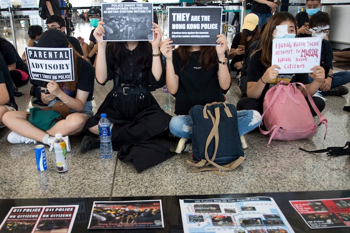 (Vincent Thian | AP Photo) Protesters stage a sit-in rally at the departure hall of the Hong Kong International Airport in Hong Kong, Tuesday, Aug. 13, 2019. Protesters clogged the departure area at Hong Kong's reopened airport Tuesday, a day after they forced one of the world's busiest transport hubs to shut down entirely amid their calls for an independent inquiry into alleged police abuse.