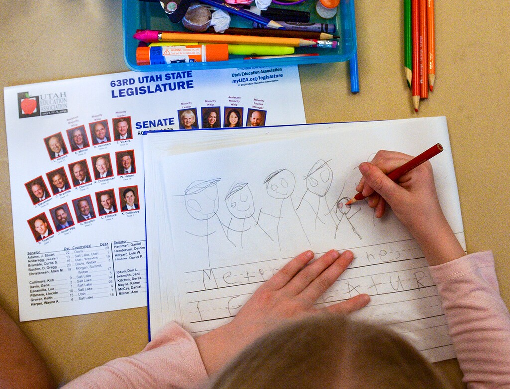 (Leah Hogsten  |  The Salt Lake Tribune) Emmy Fors, 5, draws red eyes on the likeness of members of the Utah Senate, Jan. 29, 2020.