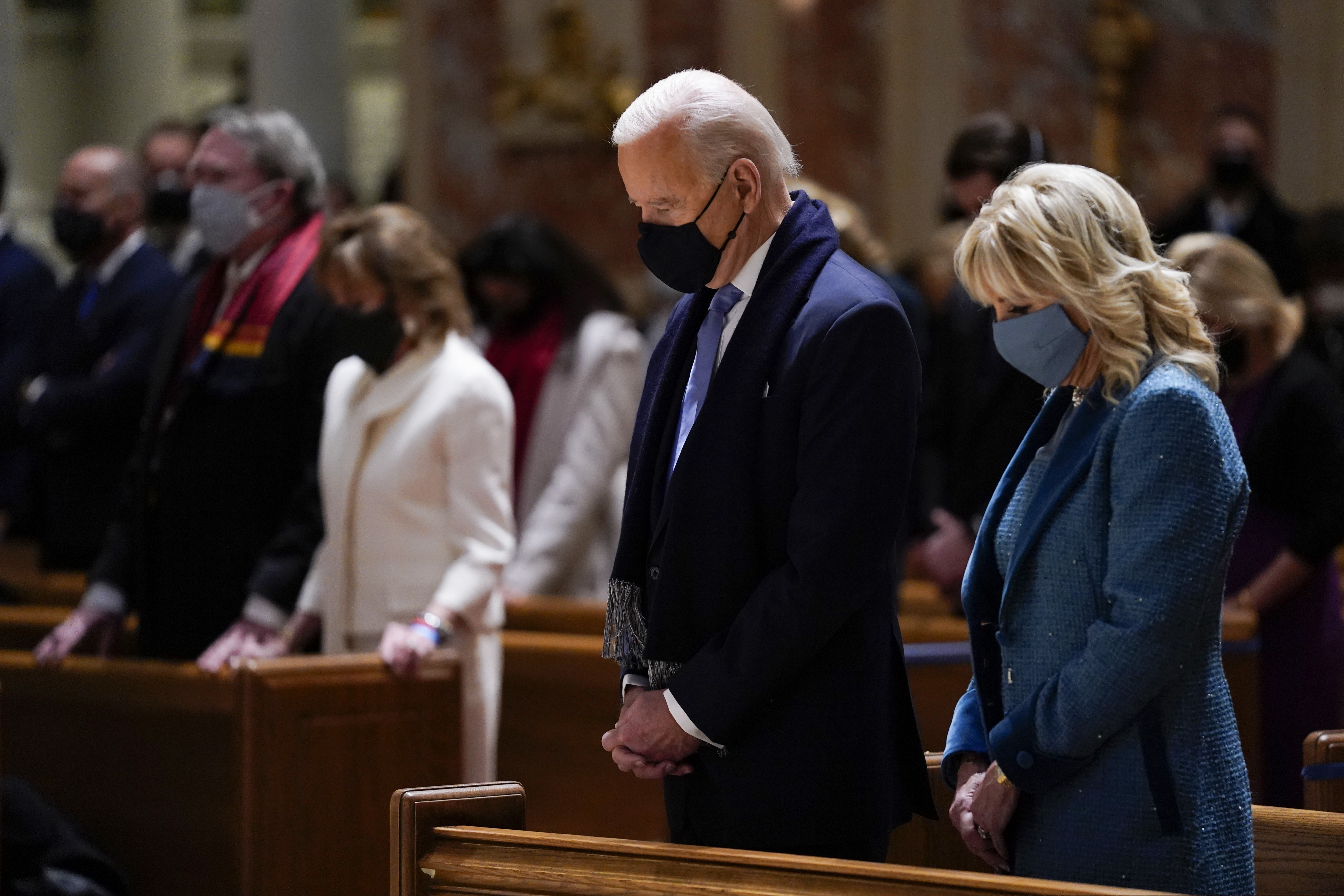 (Evan Vucci | AP)  President-elect Joe Biden and his wife Jill Biden as they attend Mass at the Cathedral of St. Matthew the Apostle during Inauguration Day ceremonies Wednesday, Jan. 20, 2021, in Washington.