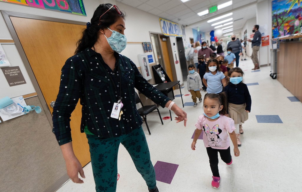 (Francisco Kjolseth | The Salt Lake Tribune) Maria Granvold guides her students back to class at Guadalupe School in Salt Lake City on Wednesday, Oct. 27, 2021. Bank of America's Neighborhood Builders program is giving a $200,000 grant to the school, an elementary school that also helps Hispanic immigrant children and adults to learn English. The school plans to expand its early learning center and after-school programs to help parents in need of child care.