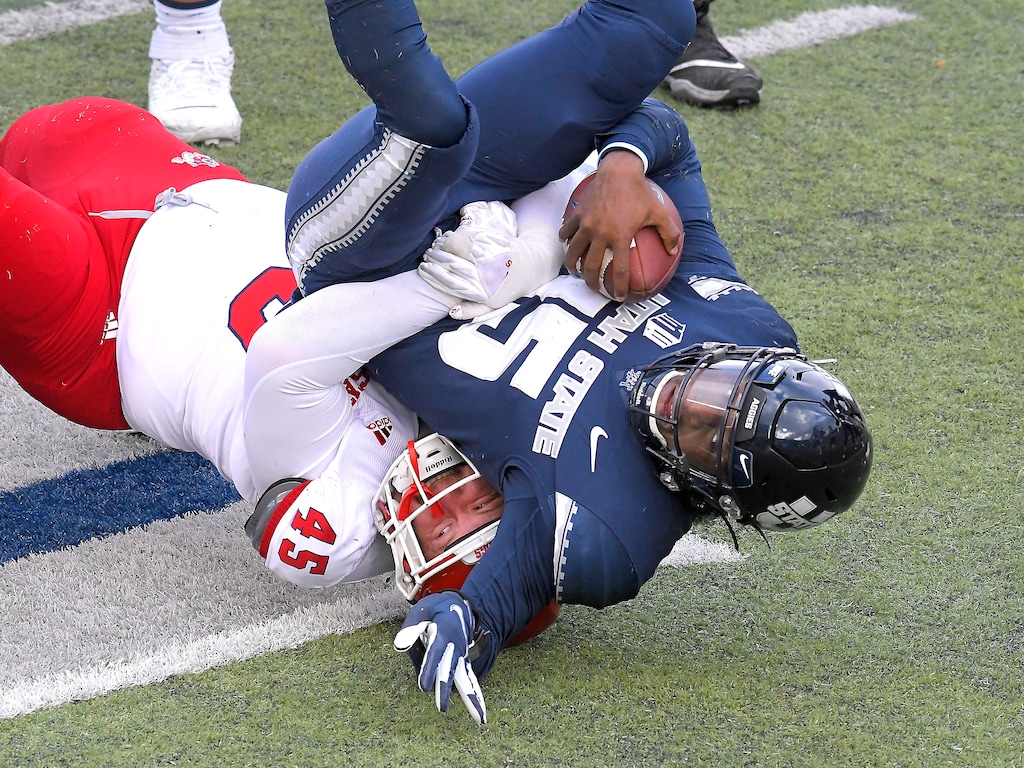 Fresno State defensive lineman Kurtis Brown (45) sacks Utah State quarterback Jason Shelley (15) during the first half of an NCAA college football game, Saturday, Nov. 14, 2020, in Logan, Utah. (Eli Lucero/Herald Journal via AP)