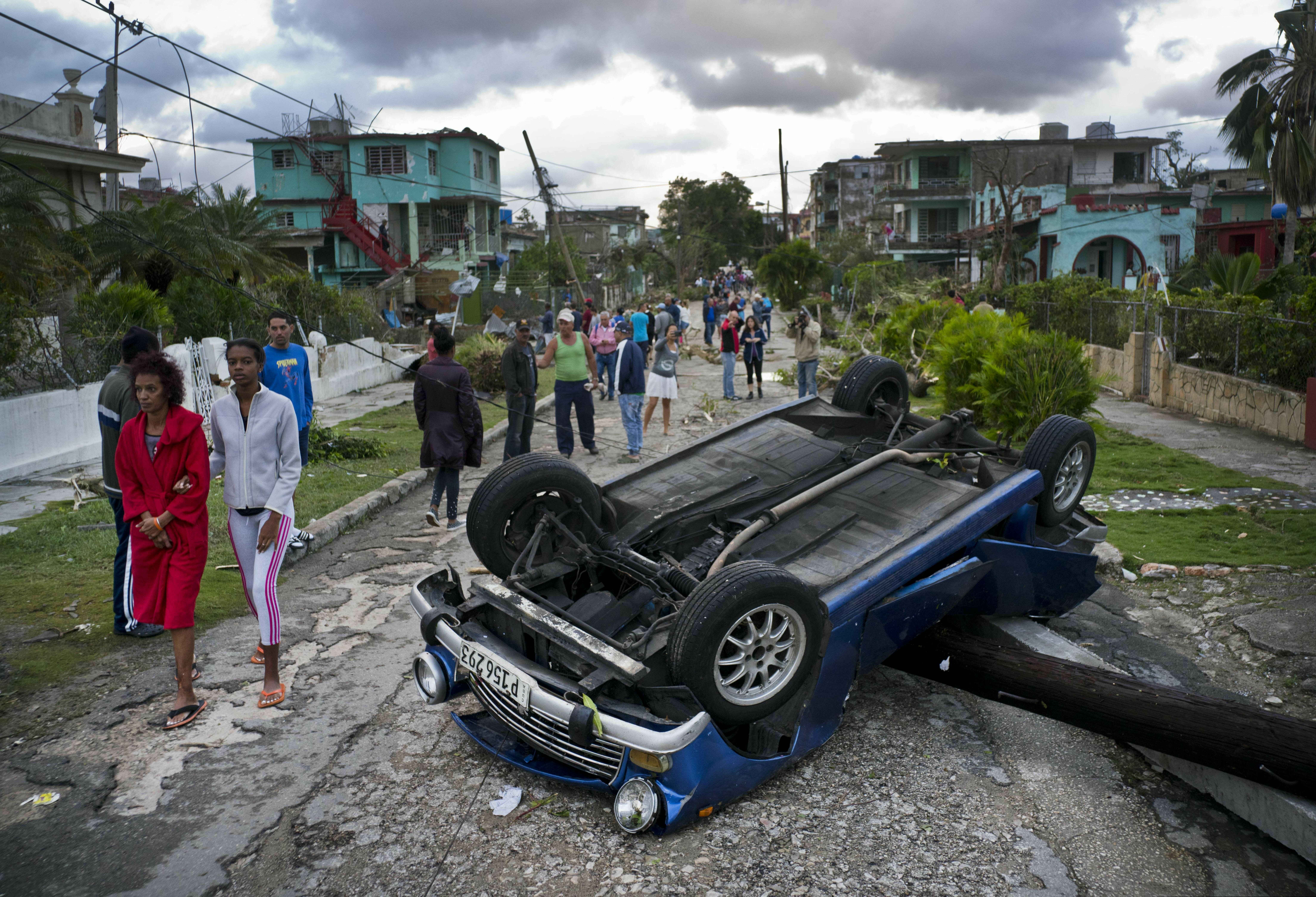 (Ramon Espinosa  |  AP Photo)  A car overturned by a tornado lays smashed on top of a street pole in Havana, Cuba, Monday, Jan. 28, 2019. A tornado and pounding rains smashed into the eastern part of Cuba's capital overnight, toppling trees, bending power poles and flinging shards of metal roofing through the air as the storm cut a path of destruction across eastern Habana.
