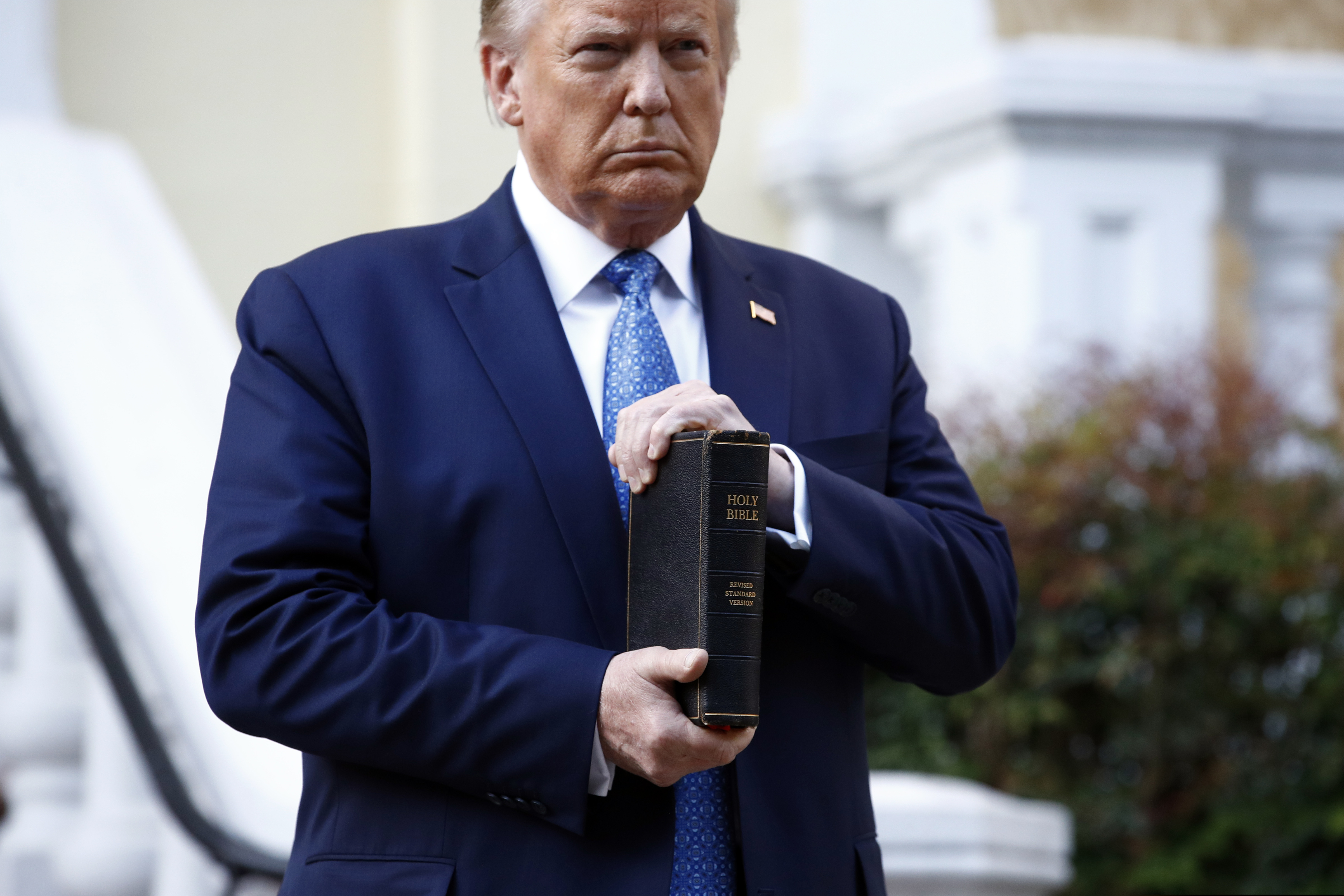 (Patrick Semansky | AP photo)
In this June 1 photo, President Donald Trump holds a Bible as he visits outside St. John's Church across Lafayette Park from the White House in Washington. Part of the church was set on fire during protests on Sunday night.