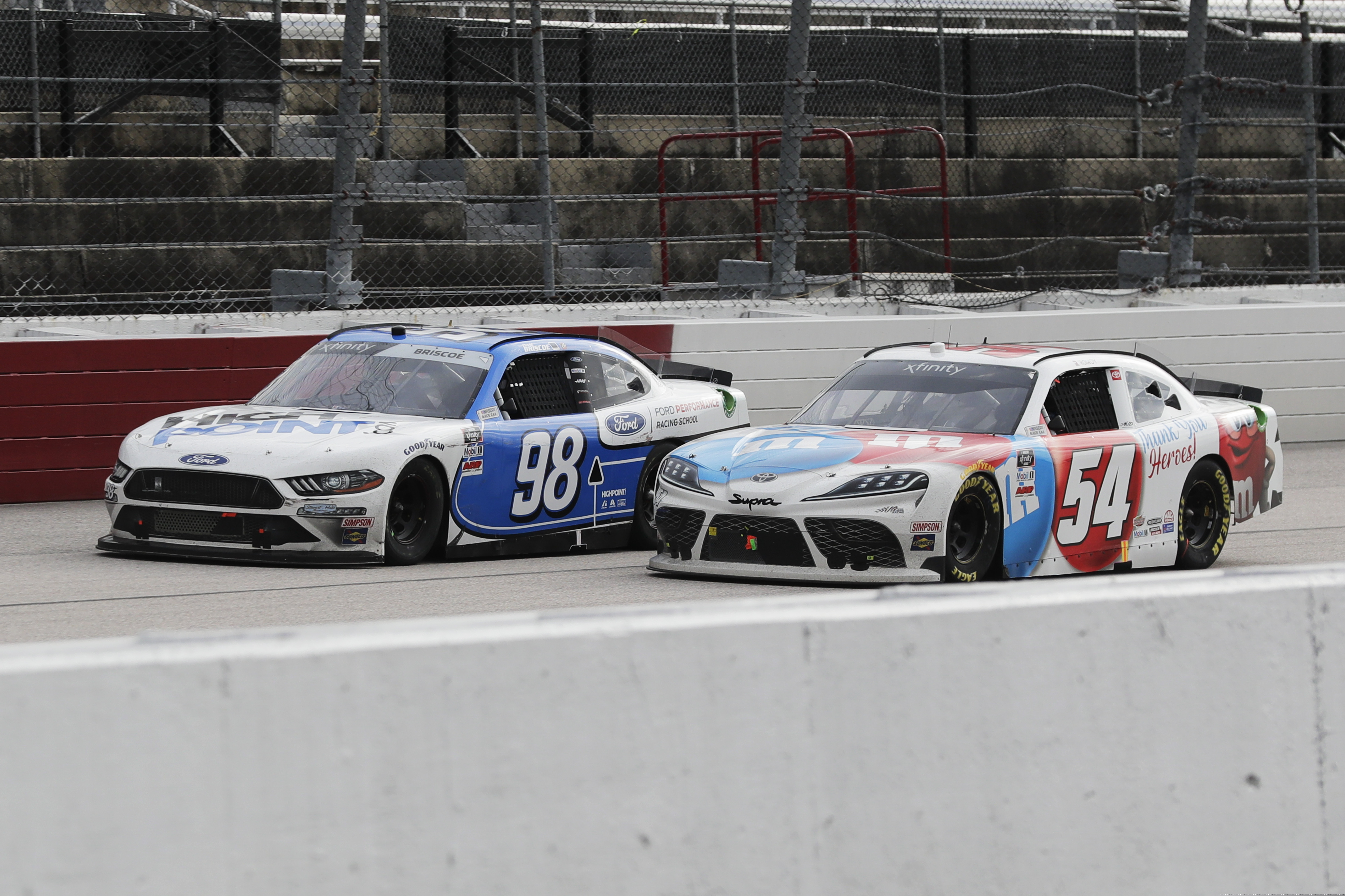 Chase Briscoe (98) leads Kyle Busch (54) on the final lap as Briscoe holds onto the lead to win the NASCAR Xfinity series auto race Thursday, May 21, 2020, in Darlington, S.C. (AP Photo/Brynn Anderson)