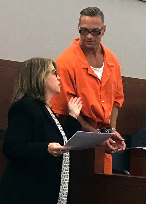 FILE - In this Aug. 17, 2017, file photo, Nevada death row inmate Scott Dozier, right, confers with Lori Teicher, a federal public defender involved in his case, during an appearance in Clark County District Court in Las Vegas. Dozier is slated to die by a three-drug lethal injection combination never before tried in any state and has said repeatedly he wants his sentence carried out and he doesn't care if it's painful. (AP Photo/Ken Ritter, File)