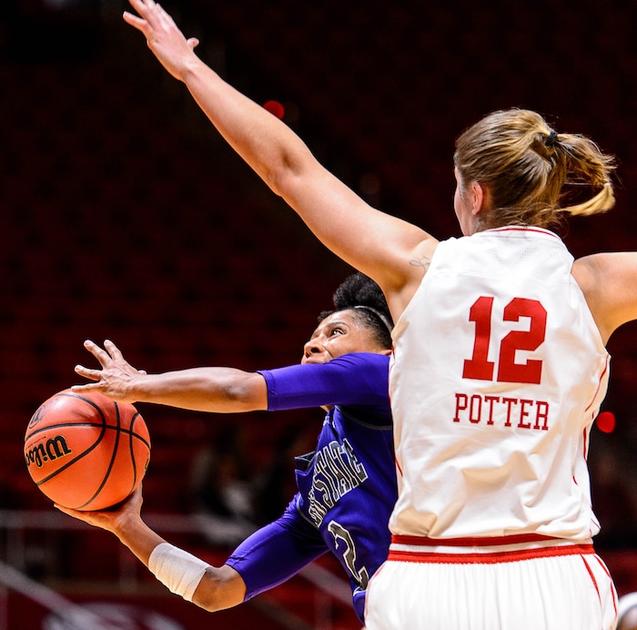 Trent Nelson  |  The Salt Lake Tribune
Weber State Wildcats guard Deeshyra Thomas (2) shoots, with Utah Utes forward Emily Potter (12) defending as University of Utah hosts Weber State, NCAA women's basketball at the Huntsman Center in Salt Lake City, Saturday December 17, 2016.