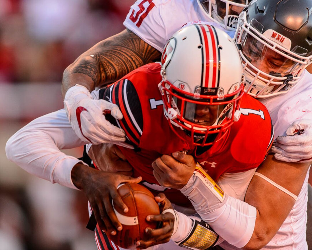 (Trent Nelson | The Salt Lake Tribune)  Utah Utes quarterback Tyler Huntley (1) is sacked by Washington State Cougars linebacker Frankie Luvu (51) and Washington State Cougars defensive lineman Hercules Mata'afa (50) as the University of Utah hosts Washington State, NCAA football in Salt Lake City, Saturday November 11, 2017.