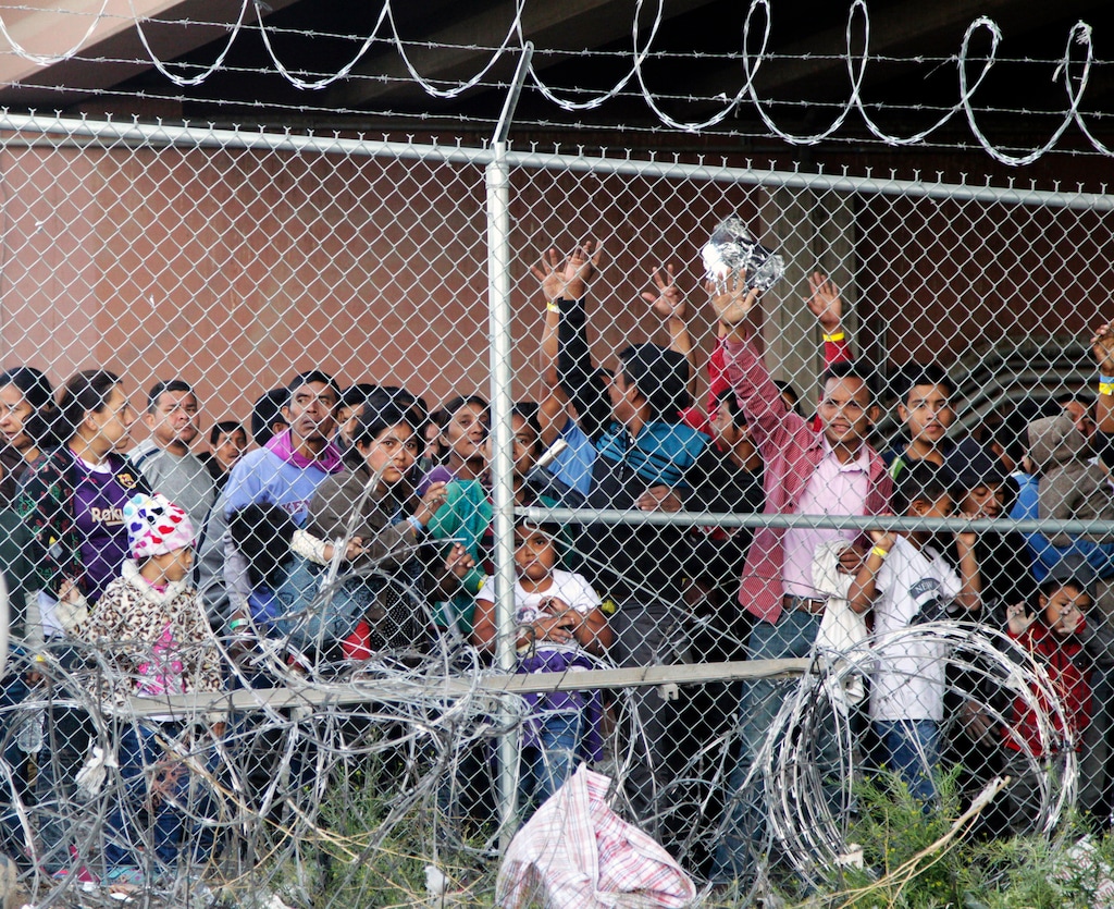 (Cedar Attanasio | AP file photo) Central American migrants wait for food in a pen erected by U.S. Customs and Border Protection to process a surge of migrant families and unaccompanied minors in El Paso, Texas. on March 27, 2019.