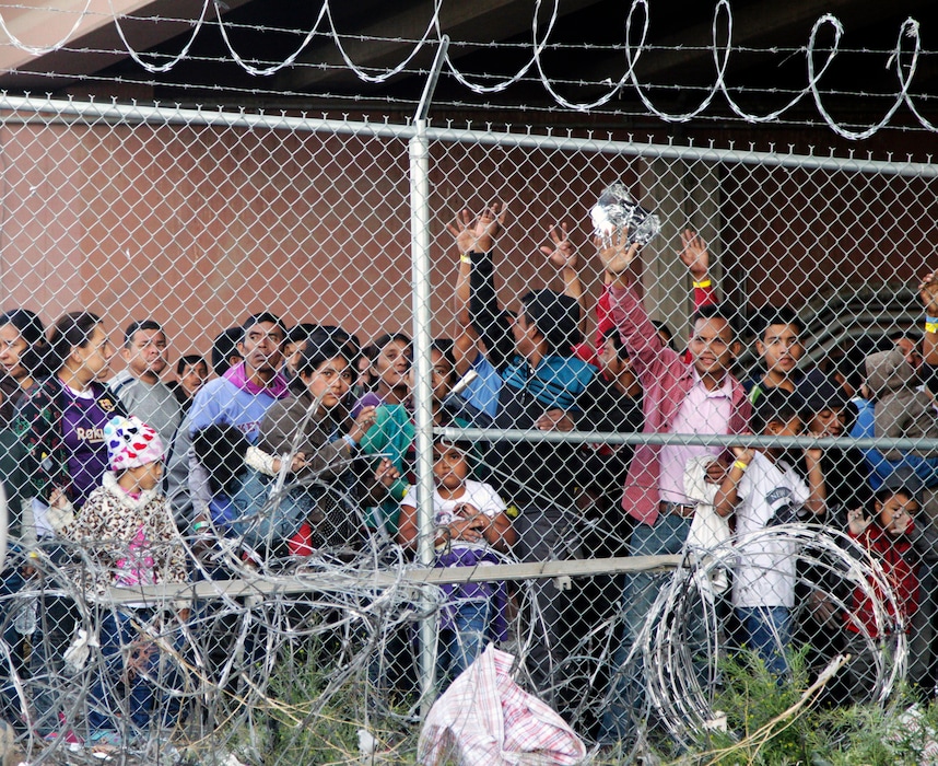 (Cedar Attanasio | AP file photo) Central American migrants wait for food in a pen erected by U.S. Customs and Border Protection to process a surge of migrant families and unaccompanied minors in El Paso, Texas. on March 27, 2019.
