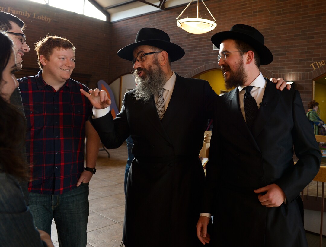 Leah Hogsten  |  The Salt Lake Tribune l-r  Rabbi Benny Zippel and Rabbi Avremi Zippel share a moment with congregants prior to the Shabbat candle lighting. Jewish women in Utah at the Chabad Lubavitch of Utah and the world over kindled Shabbat candles, May 3, 2019 in loving tribute to Lori Gilbert-Kaye and in prayer for peace and tolerance amongst all of humanity. Lori Kaye was killed during The Chabad of Poway synagogue shooting on the last day of Passover and three others were injured. Although the lighting of Shabbat Candles is uniquely tasked to the Jewish woman, the  community and those wishing to show their support were welcome to attend.