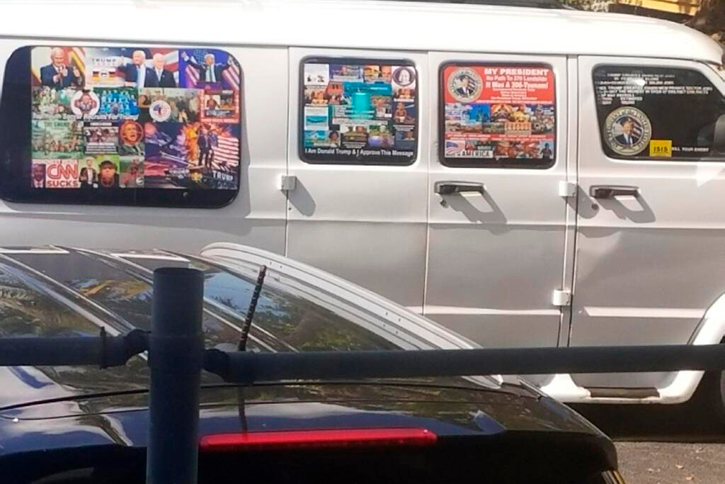 (Lesley Abravanel | The Associated Press) This Nov. 1, 2017, photo shows a van with windows covered with an assortment of stickers in Well, Fla. Federal authorities took Cesar Sayoc into custody on Friday, Oct. 26, 2018, and confiscated his van, which appears to be the same one, at an auto parts store in Plantation, Fla., in connection with the mail-bomb scare that has targeted prominent Democrats from coast to coast.