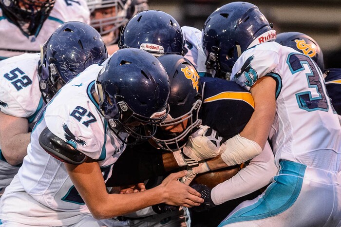 (Trent Nelson | The Salt Lake Tribune)  Summit Academy's Talmage Brown is brought down by Juan Diego defenders. Summit Academy faces Juan Diego High School in a class 3A state semifinal football game at Weber State University's Stewart Stadium, Saturday November 4, 2017.