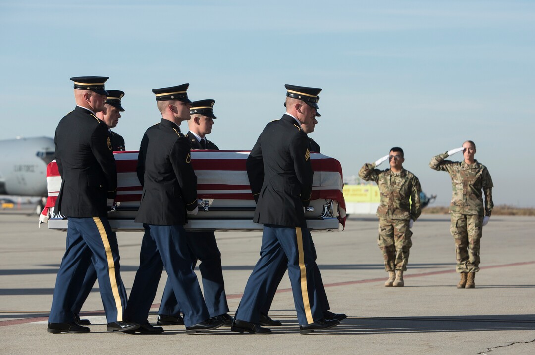 (Matt Herp  |  The Ogden Standrad Examiner/Pool) Utah National Guard Honor Guard Detail members carry a casket containing the remains of Maj. Brent R. Taylor at Roland R. Wright Air National Guard Base in Salt Lake City, Utah, on Wednesday, Nov. 14, 2018. Taylor, 39, of North Ogden, died Nov. 3, 2018, in Afghanistan of wounds sustained from small arms fire. His funeral is scheduled for Saturday, Nov. 17, in Ogden.