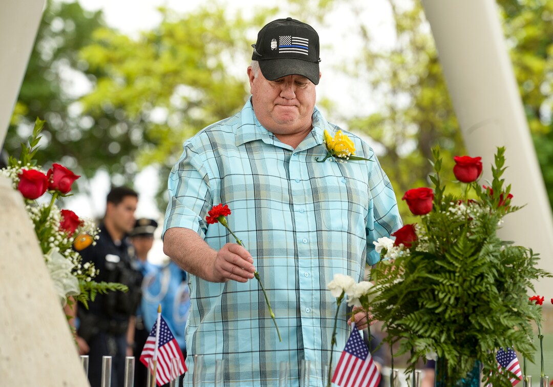 (Leah Hogsten  |  The Salt Lake Tribune)  Tim Jackson honors the memory of his great-grandfather Officer Brigham H. Honey, Jr. and his partner William N. Huntsman who died in the line of duty on February 16, 1924. In honor of Police Week, the Salt Lake City Police Department honored its fallen officers with a memorial service and a 21-gun salute at the Public Safety Building, Thursday, May16, 2019.