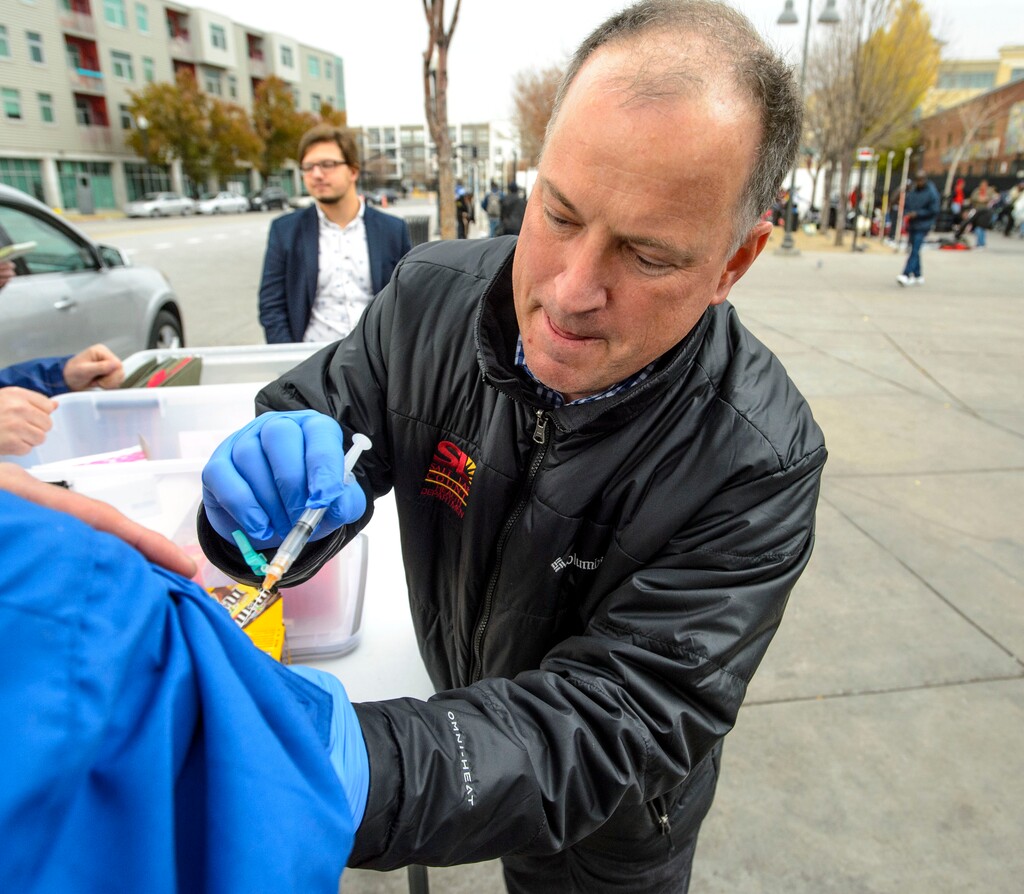 (Steve Griffin  |  Tribune file photo) Steven Beach, a registered nurse with the Salt Lake County Health Department, administers a hepatitis A vaccination at a mobile vaccination clinic set up outside at 500 West and 200 South in Salt Lake City,  as seen in November 2017. In spite of two recently announced deaths from the disease, Utah officials are hoping an outbreak that began over the summer is gradually waning.