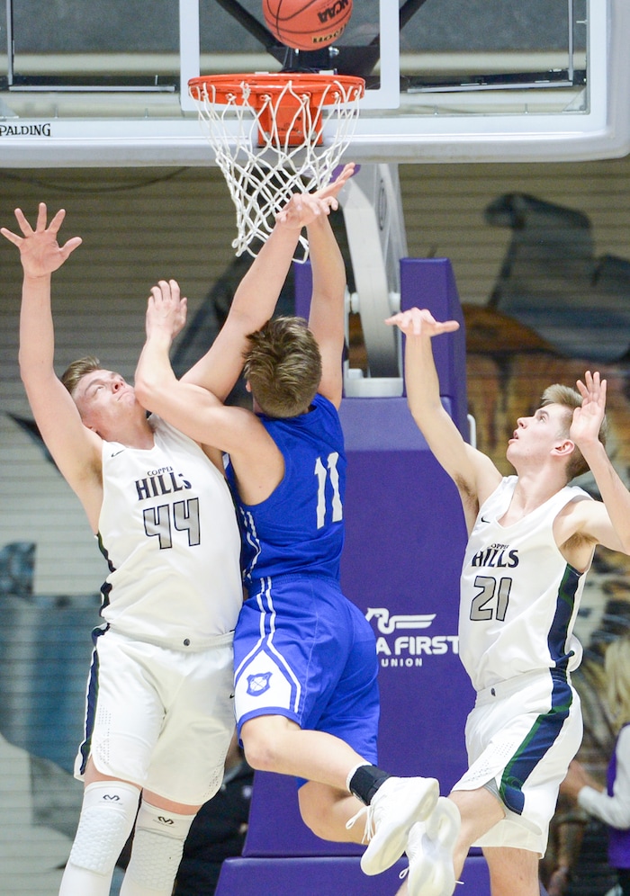 (Leah Hogsten  |  The Salt Lake Tribune) Bingham's Dalton Miller (11) gets the ball swatted away by Copper Hills' Trevon Allfrey (44). Copper Hills defeated Bingham 61-54 in the 6A High School Boys' Basketball Tournament opening game at Weber State University’s Dee Events Center in Ogden, Tuesday, Feb. 27, 2018. 