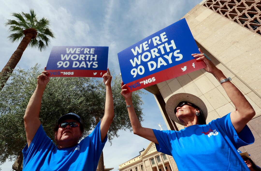 Roger Parrish and Diane Johnson, right, rally outside the Capitol in Phoenix, Wednesday, June 6, 2018. Hundreds of Navajo Generating Station employees, relatives and union and tribal leaders rallied at the state Capitol in Phoenix on Wednesday to request a 90-day pause in steps to close the coal-fueled plant by the end of 2019 as scheduled. (AP Photo/Matt York)