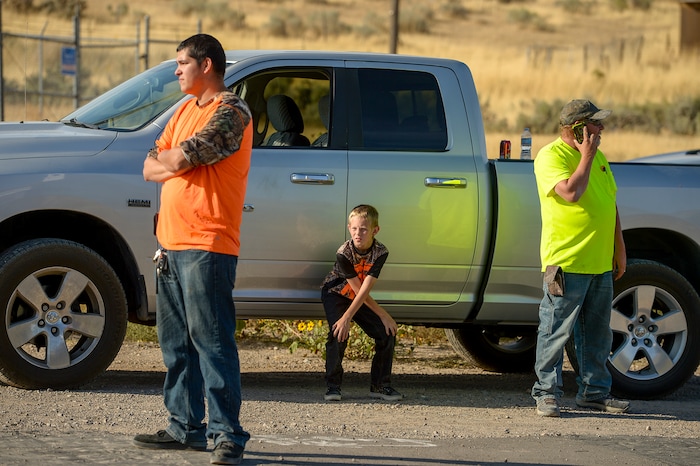 Leah Hogsten  |  The Salt Lake Tribune    l-r Martin Garcia, Colby Lovendahl, 8, and Danny Lovendahl of Herriman watch as the blaze burns 1/4mile from their home. They waited for hours to be allowed to get back to their wives and children who did not leave the home as the fire burned. A 50-acre wildfire in Rose Canyon was threatened about a half-dozen homes Wednesday, Sept. 12, 2018. A spokesman for Unified Fire said the blaze has already burned a few structures, including outhouses and sheds. Firefighters have evacuated around 20 to 30 homes in two neighborhoods near 15555 S. Rose Canyon Road in Herriman. 