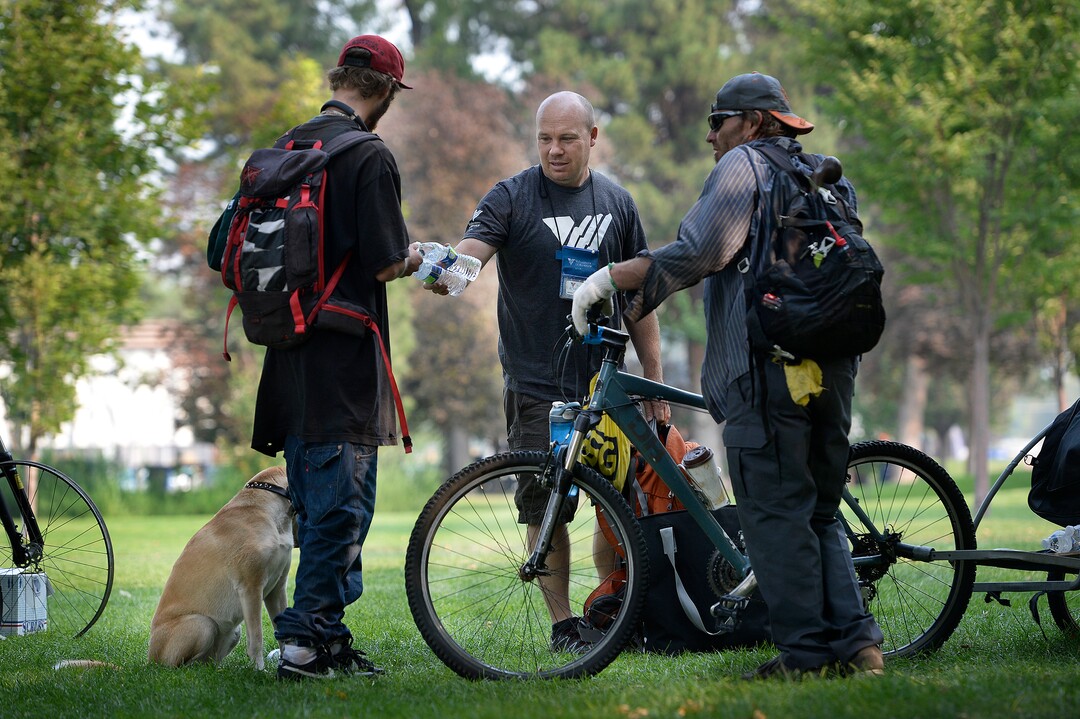 (Scott Sommerdorf   |  The Salt Lake Tribune)   Sean Spalding, of the Volunteers of America, hands out some supplies to homeless men in Fairmont Park, Wednesday, September 6, 2017.