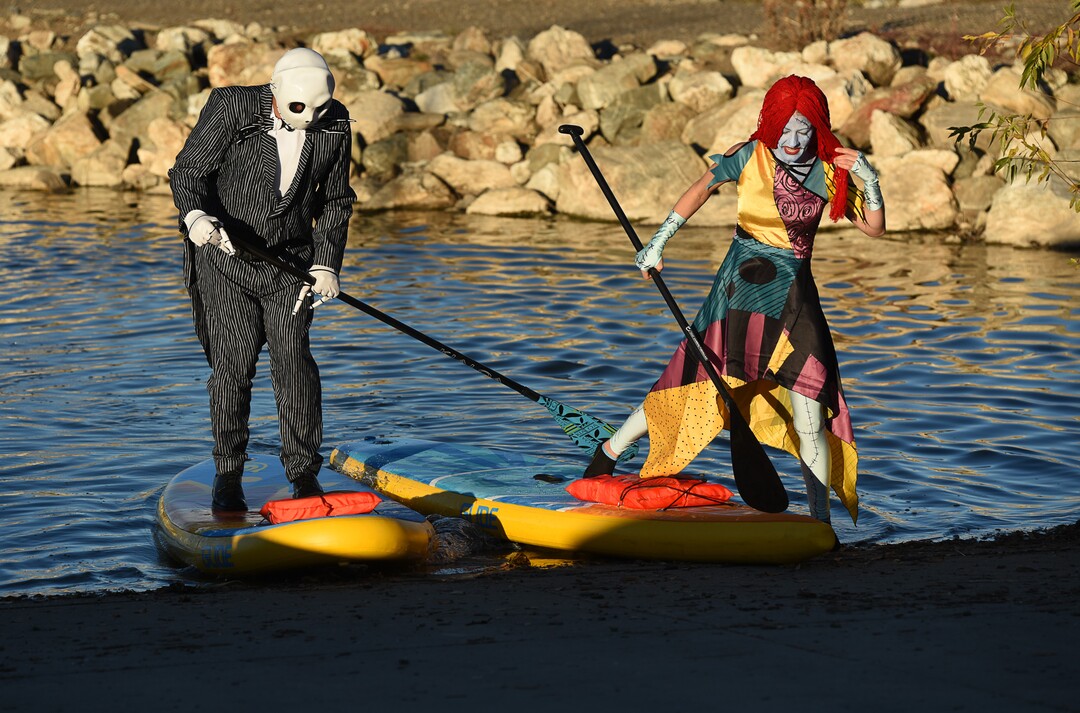 (Francisco Kjolseth  |  The Salt Lake Tribune)  Stand up paddle board enthusiasts Chris Knoles and Roxy Christensen take to the water at Bountiful Pond on Tuesday, Oct. 30, 2018, in what has become a Halloween tradition for the 4th year in a row as they dress up this year as Jack and Sally Skellington from the movie Nightmare Before Christmas. "We paddle year round but actually paddle more in the winter," exclaimed Knoles, who carry the tradition on at Christmas, dressing up in something festive and paddling on the Great Salt Lake where the high salinity usually keeps the water from freezing.