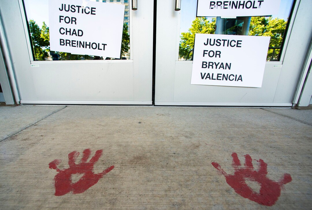 (Rick Egan  |  The Salt Lake Tribune)     Protesters put new signs on the Salt Lake District Attorney's Office, during a protest to draw attention to Chad Breinholt and Bryan Valencia, who, like Bernardo Palacios were killed by the police, Wednesday, July 8, 2020.