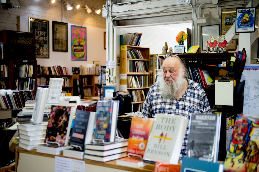 (Jeremy Harmon  |  The Salt Lake Tribune) Ken Sanders works in his bookstore on Tuesday, March 24, 2020. His business has been hit hard because of coronavirus fears, and he has now asked employees to quarantine at home.