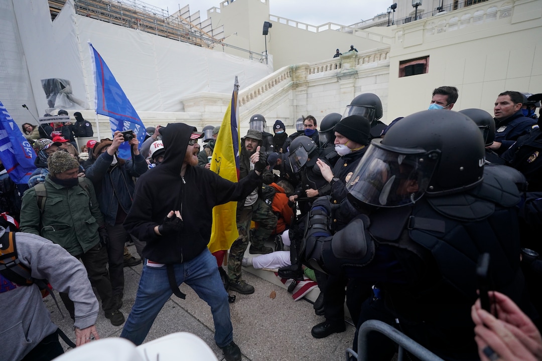 Trump supporters try to break through a police barrier, Wednesday, Jan. 6, 2021, at the Capitol in Washington. As Congress prepares to affirm President-elect Joe Biden's victory, thousands of people have gathered to show their support for President Donald Trump and his claims of election fraud. (AP Photo/Julio Cortez)