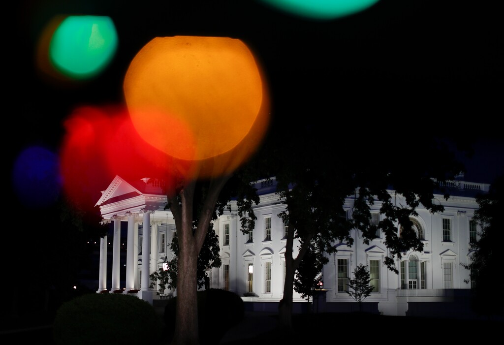 The White House is seen Washington, Saturday, June 3, 2017, photographed through colored lights hanging in a television broadcast position. (AP Photo/Carolyn Kaster)