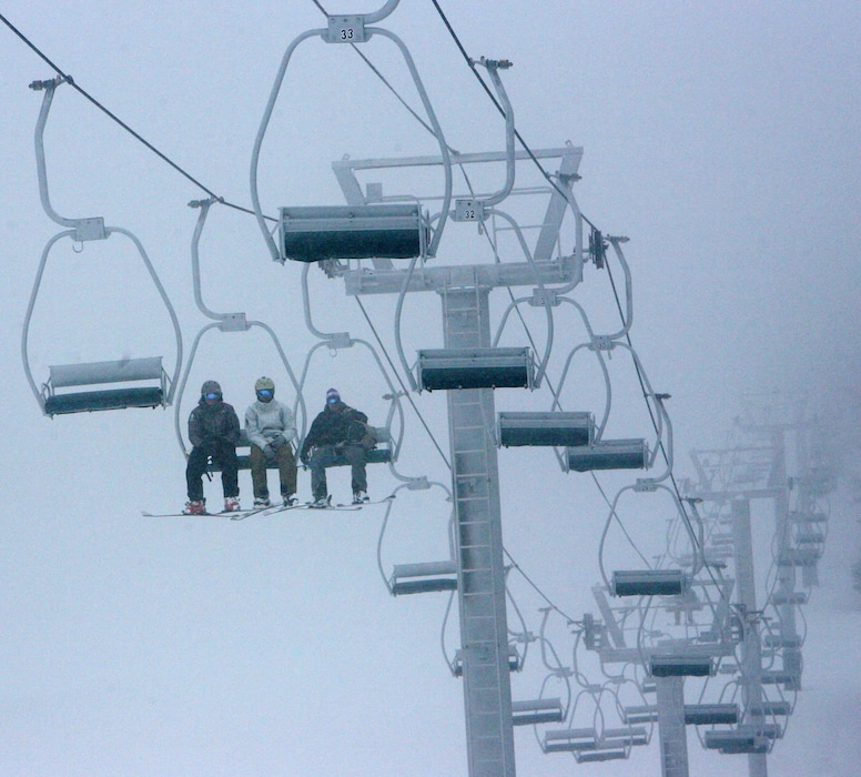 (Steve Griffin | The Salt Lake Tribune) Skiers brave fog and snow as they ride the ski lift during opening day at Eagle Point ski resort above Beaver in 2010. The resort announced Tuesday, March 12, 2024, that it is adopting a new policy of letting kids 12-under ski and snowboard for free.