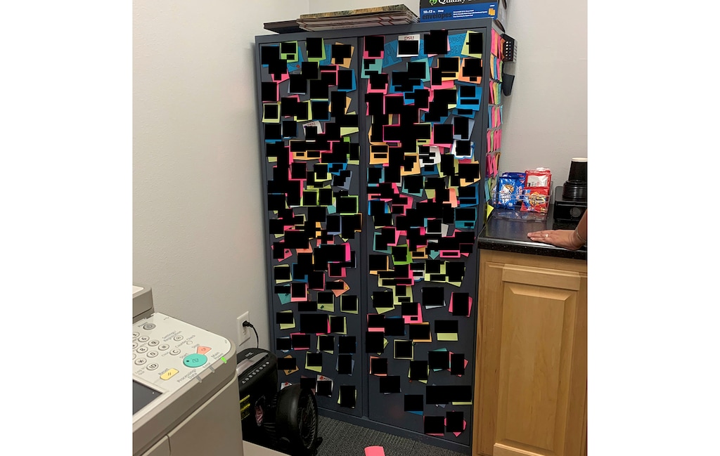 (Screenshot) Pictured is the cabinet at Utah Tech University that was covered with Post-it notes — which have been redacted for privacy in this photo — that included crude sayings from staff members of the school's marketing department. The notes are part of a lawsuit filed by three employees who allege there was a toxic culture at the university.