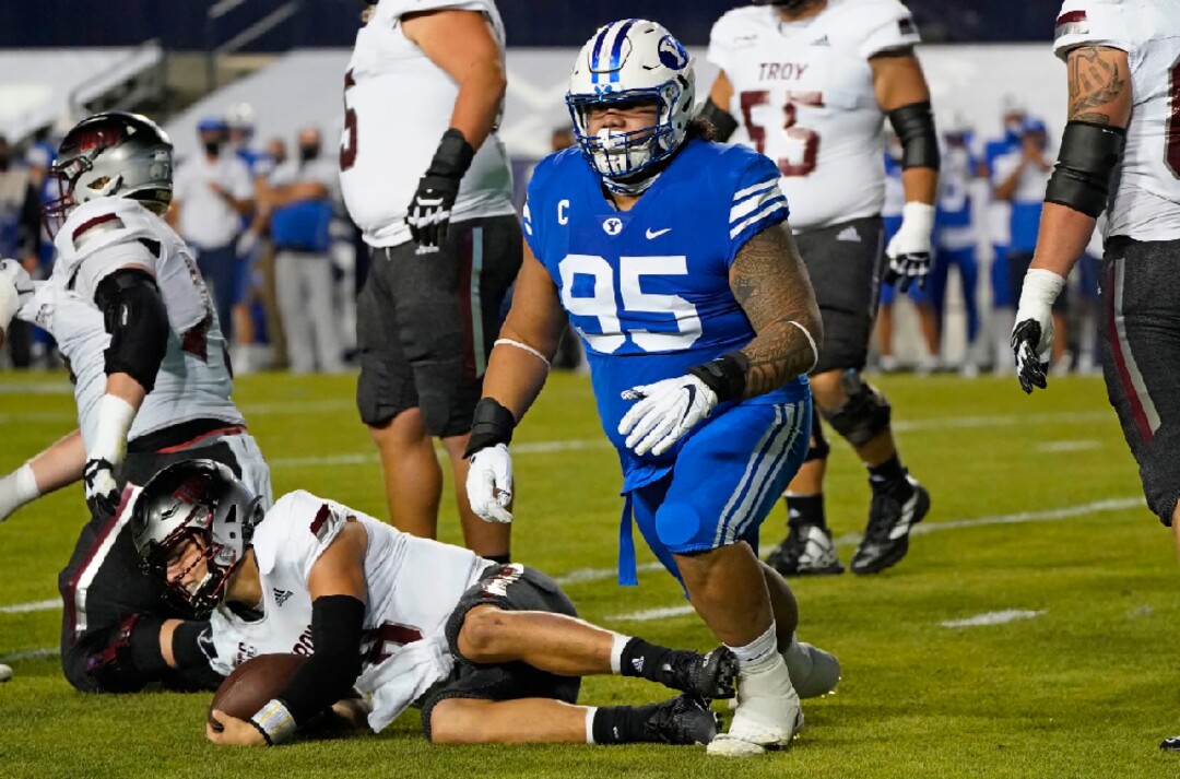 BYU defensive lineman Khyiris Tonga (95) gets up after sacking Troy quarterback Gunnar Watson during the first half of an NCAA college football game Saturday, Sept. 26, 2020, in Provo, Utah. (AP Photo/Rick Bowmer, Pool)