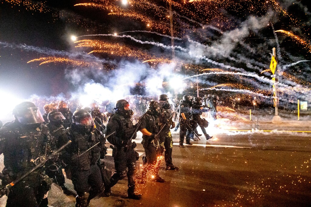 (Noah Berger | AP file photo)  Police use chemical irritants and crowd control munitions to disperse protesters during a demonstration in Portland, Ore., Saturday, Sept. 5, 2020.