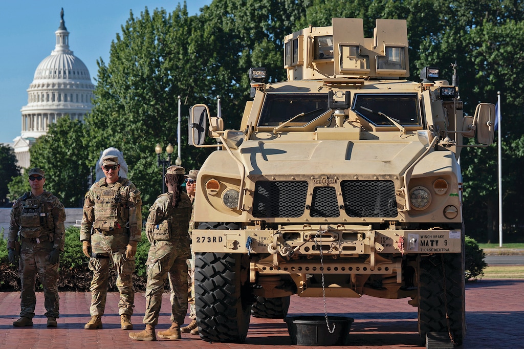 Members of the District of Columbia National Guard standing next to an MATV vehicle scan the area as they patrol outside Union Station, Monday, Sept. 1, 2025, in Washington. (AP Photo/Jose Luis Magana)