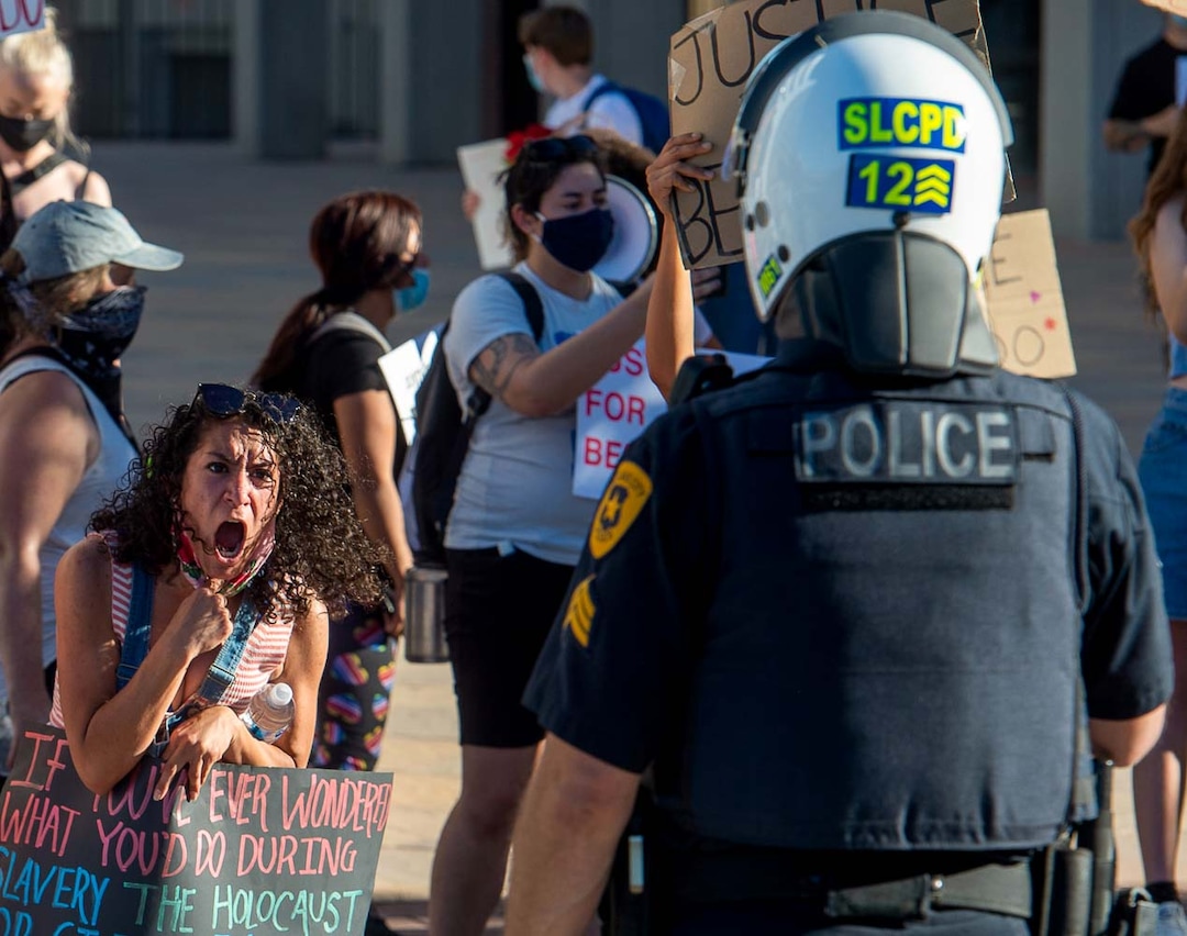 (Rick Egan | The Salt Lake Tribune) Hailee  Hernandez shouts at a Salt Lake City policeman, as the police threaten  protesters with arrest if they step off of the sidewalk.