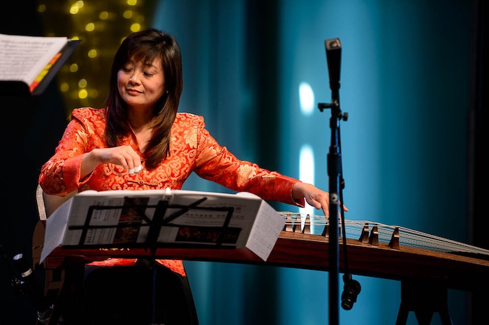 (Trent Nelson | The Salt Lake Tribune)  Yun Layton plays the guzheng with the Utah Chinese Folk Orchestra performs at the Chinese New Year Celebration at the County Library's Viridian Event Center in West Jordan, Saturday Feb. 17, 2018.