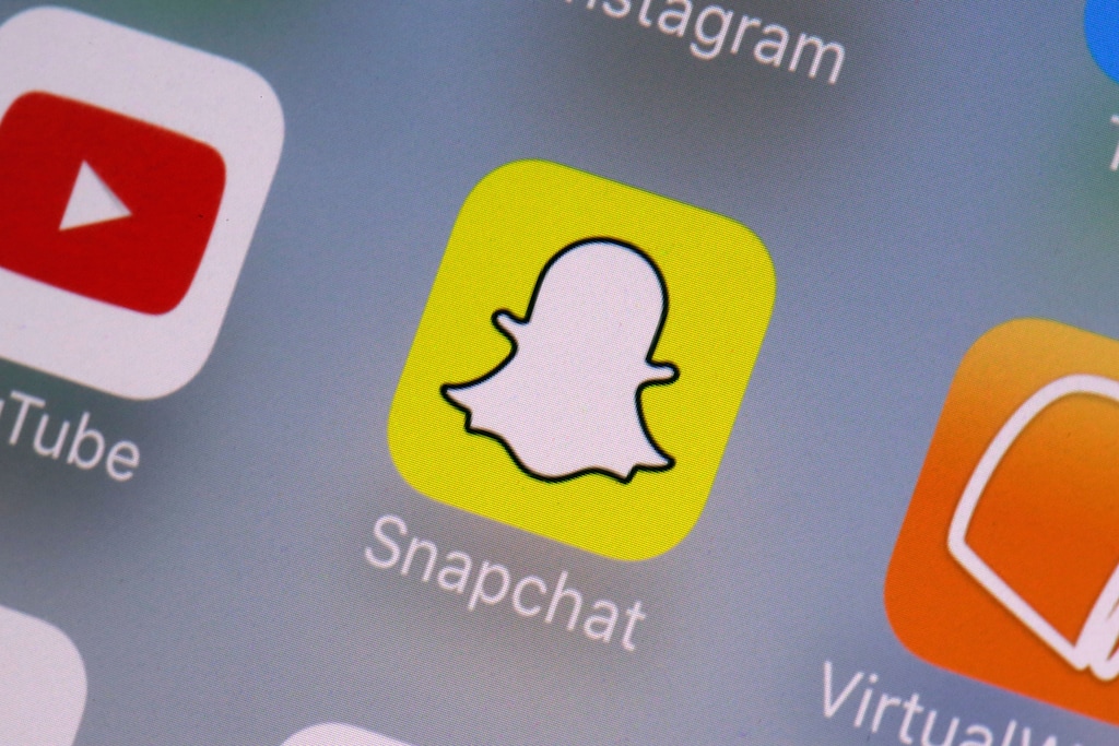 (Richard Drew | The Associated Press) This Aug. 9, 2017, file photo shows the Snapchat app on a mobile device in New York. Snapchat is joining the online-games bandwagon with a new service that lets people play together on its mobile platform. The company says it wants to make it easier for friends to play together.