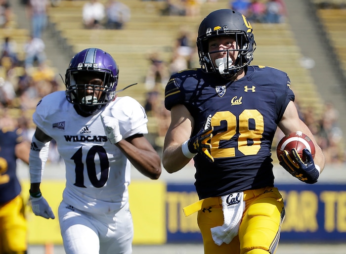 California running back Patrick Laird (28) runs past Weber State cornerback Keilan Benjamin (10) to score a touchdown during the first half of an NCAA college football game in Berkeley, Calif., Saturday, Sept. 9, 2017. (AP Photo/Jeff Chiu)