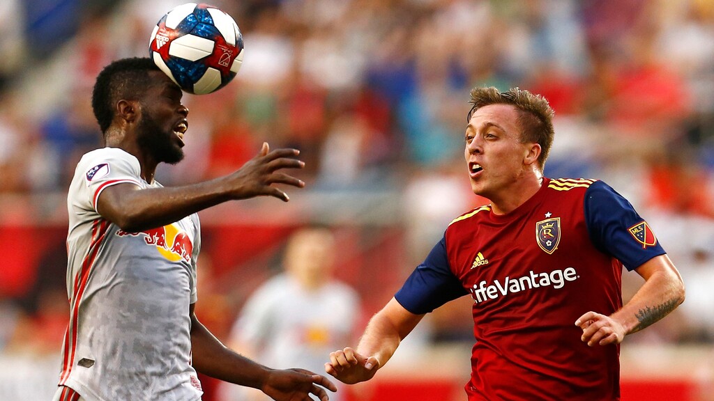 New York Red Bulls defender Kemar Lawrence, left, heads the ball in front of Real Salt Lake forward Corey Baird during the first half of an MLS soccer match Saturday, June 1, 2019, in Harrison, N.J. (AP Photo/Adam Hunger)