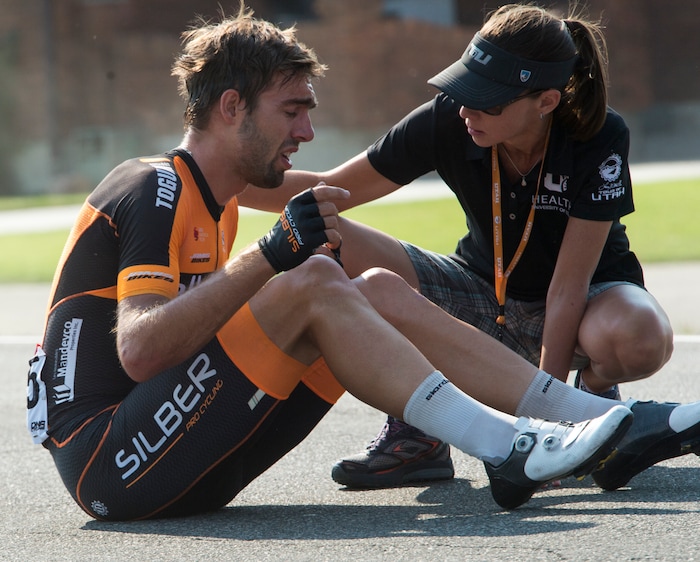 (Rick Egan  |  The Salt Lake Tribune)  Emile Jean gets some medical assistance after a pile up near Hooper, in the Tour of Utah Stage 5, Friday, August 4, 2017.


