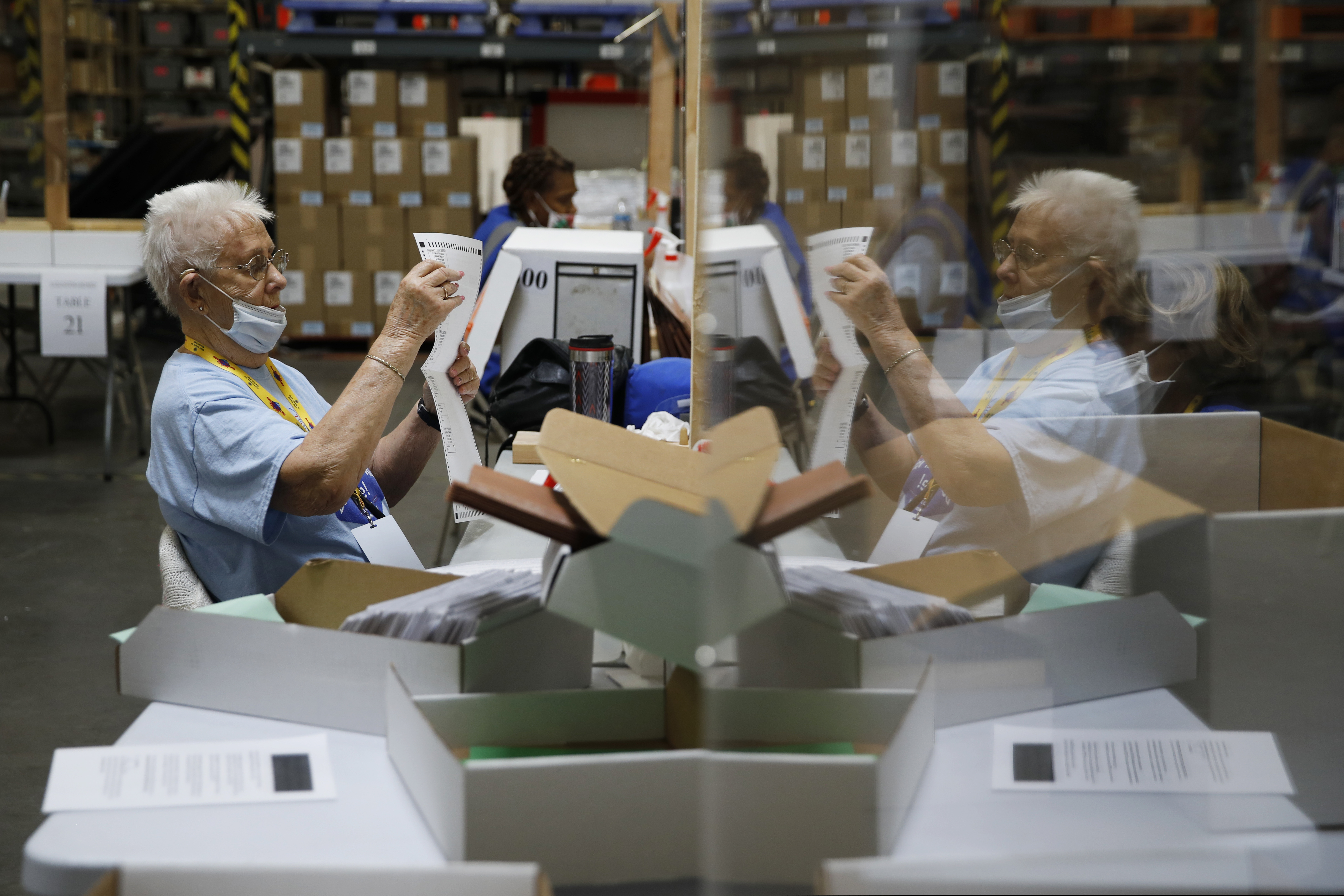 (John Locher | AP photo)
In this June 9 photo, election workers process mail-in ballots during a nearly all-mail primary election in Las Vegas. The Trump campaign and Nevada Republicans want a state judge to stop the counting of Las Vegas-area mail-in ballots, alleging that "meaningful observation" of signature-checking is impossible in the state's biggest and most Democratic-leaning county. The lawsuit filed 10 days before the Nov. 3 election alleges the local elections chief failed to get proper approval in April from the Secretary of State for the vote plan.