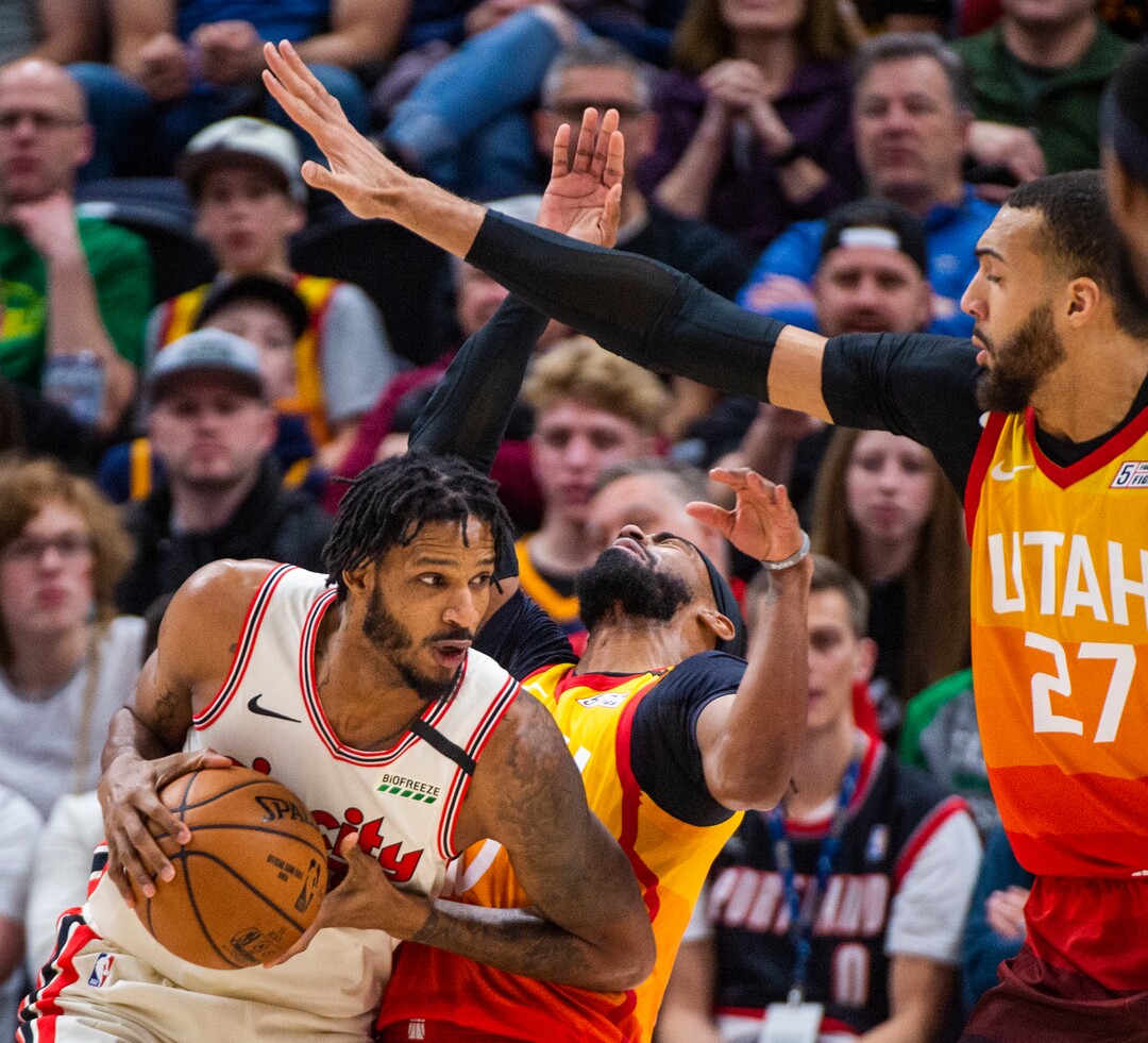 (Rick Egan  |  The Salt Lake Tribune)     Utah Jazz guard Mike Conley (10) and Utah Jazz center Rudy Gobert (27) guard Portland Trail Blazers forward Trevor Ariza (8), in NBA action between the Utah Jazz and thePortland Trail Blazers in Salt Lake City, Friday, Feb. 7, 2020.