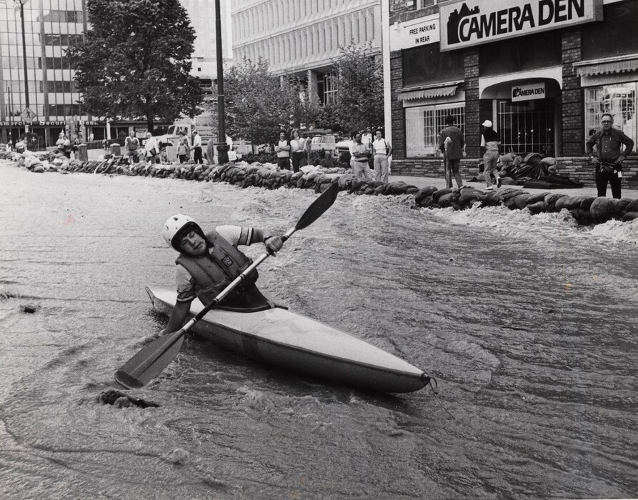 (The Salt Lake Tribune) East High School student Michael C. Giddings navigates the upper headwaters of State Street during flooding in 1983.