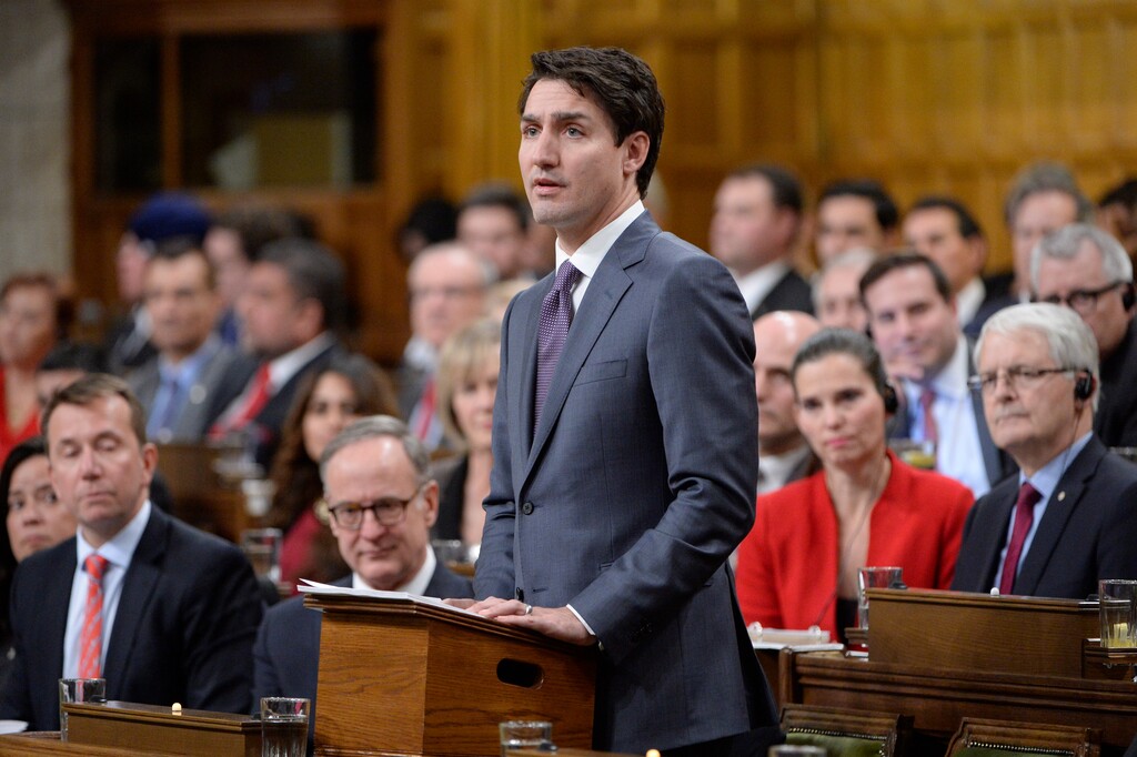 Prime Minister Justin Trudeau makes a formal apology to individuals harmed by federal legislation, policies, and practices that led to the oppression of and discrimination against LGBTQ2 people in Canada, in the House of Commons in Ottawa, Tuesday, Nov. 28, 2017. (Adrian Wyld/The Canadian Press via AP)