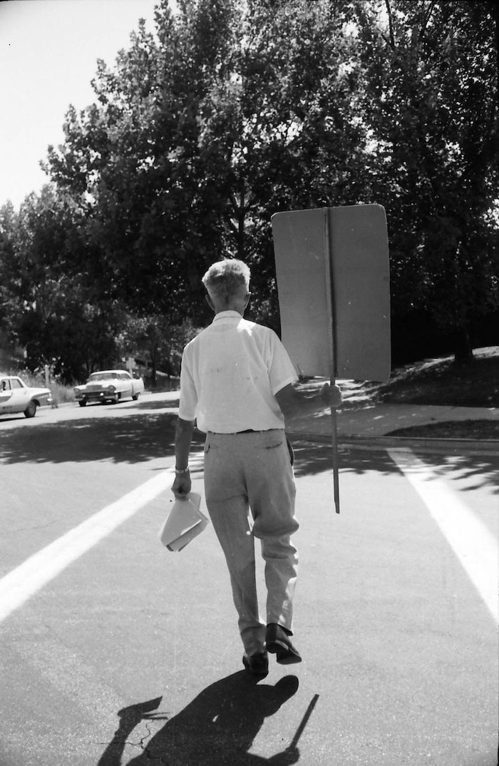 (photo courtesy Jerry Currier)  Ammon Hennacy walks away from the State Capitol after picketing on behalf of three death row inmates in 1961.