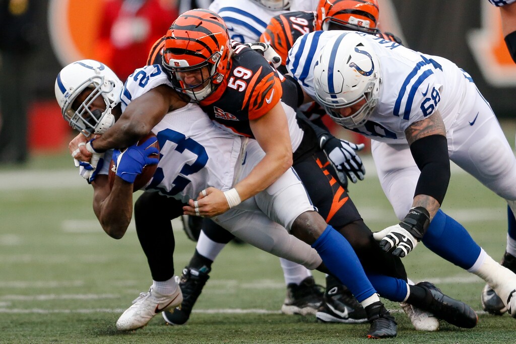 Indianapolis Colts running back Frank Gore (23) is tackled by Cincinnati Bengals outside linebacker Nick Vigil (59) in the second half of an NFL football game, Sunday, Oct. 29, 2017, in Cincinnati. (AP Photo/Gary Landers)