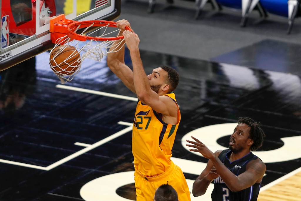 Utah Jazz center Rudy Gobert (27) scores in front of Orlando Magic forward Al-Farouq Aminu (2) in the first quarter during an NBA basketball game, Saturday Feb. 27, 2021, in Orlando, Fla. (AP Photo/Joe Skipper)