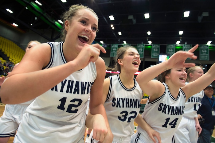 Scott Sommerdorf | The Salt Lake TribuneLauren Gustin, left, celebrates with team mates Sydney Sorensen, #32, and Kaylee Brimhall, #14, after winning the state title. Salem Hills beat Hurricane 57-35 for the 4A girl's title, Saturday, March 3, 2018.