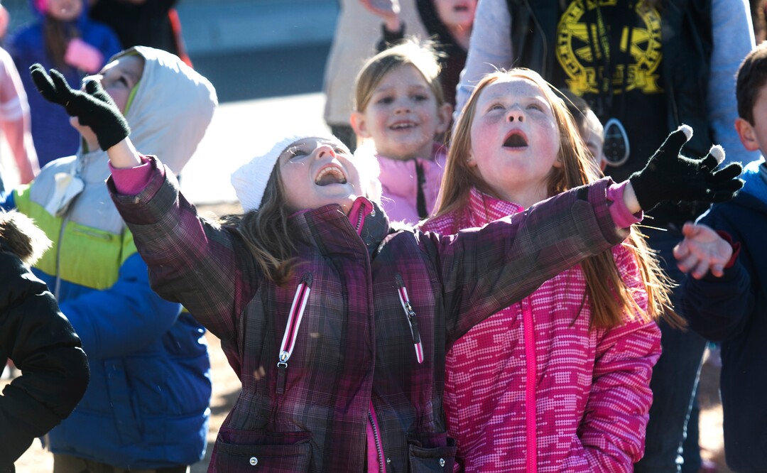(Rick Egan  |  The Salt Lake Tribune) First graders Jaxie Marx and Rebecca Marshallwatch the skies as Santa and Mrs Claus arrive in a helicopter, at Centennial Elementary School, in Roosevelt, Utah, as volunteer pilots from the Utah Wing of Angel Flight West,  brought school supplies and gifts to students  on their annual Santa Flight. Friday, December 8, 2017.