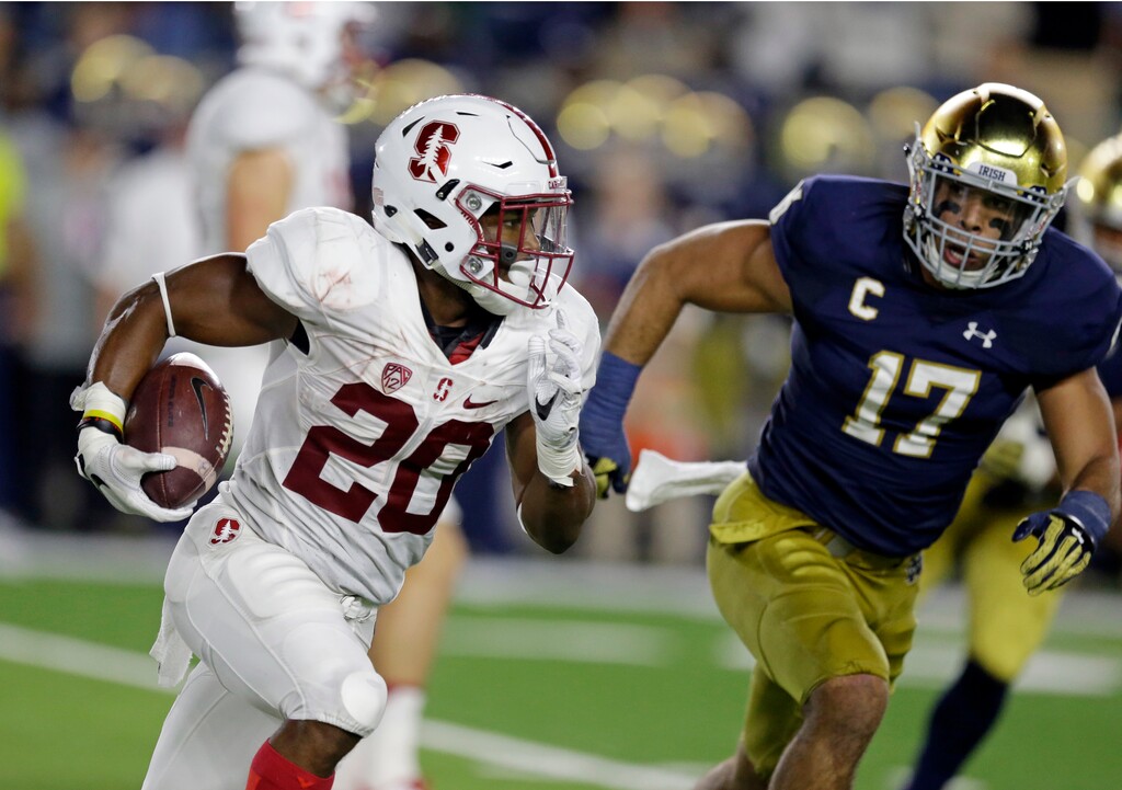 (AP Photo/Michael Conroy) Stanford running back Bryce Love (20) runs against Notre Dame in a 2016 game.